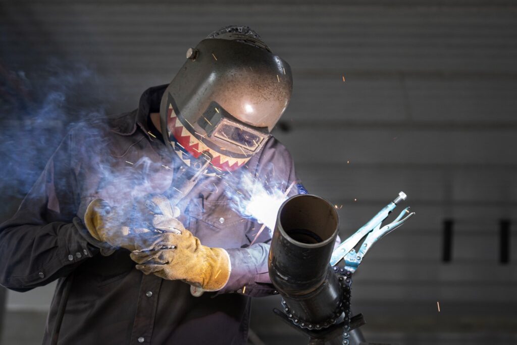 Dude in cool welding hood welding some 4 inch pipe with 7018