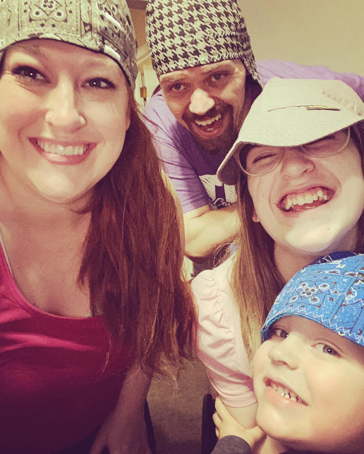 Two of my kids, my wife, and myself after getting some new welding beanies in the house.